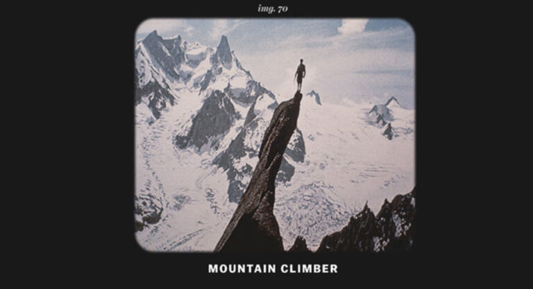 a picture of a person standing atop an extremely narrow and steep pinnacle